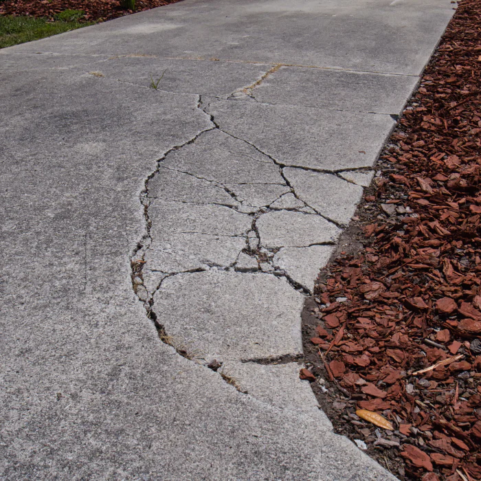 concrete driveway with damage menan id