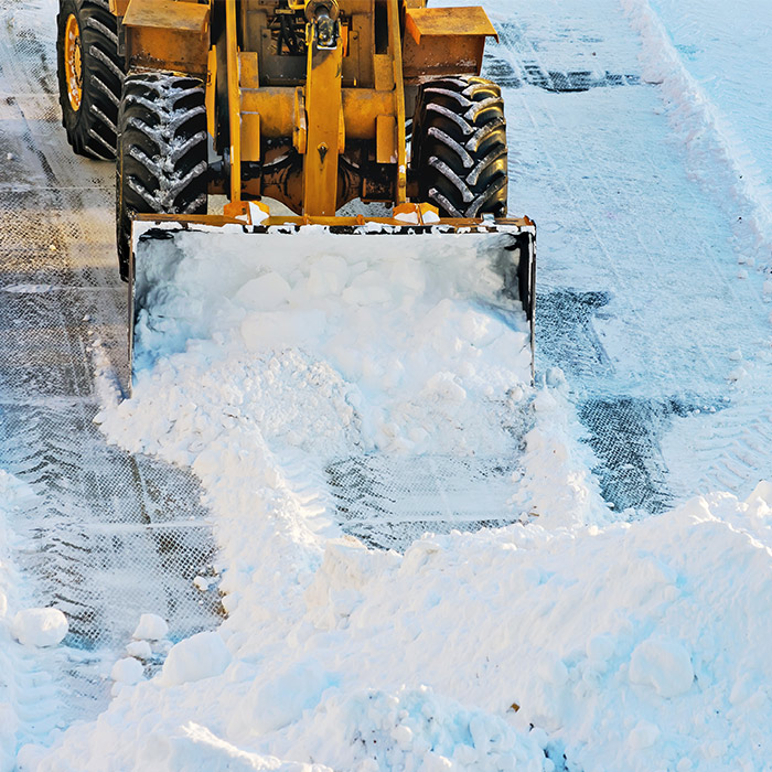 bulldozer close up snow plowing at property exteriors menan id